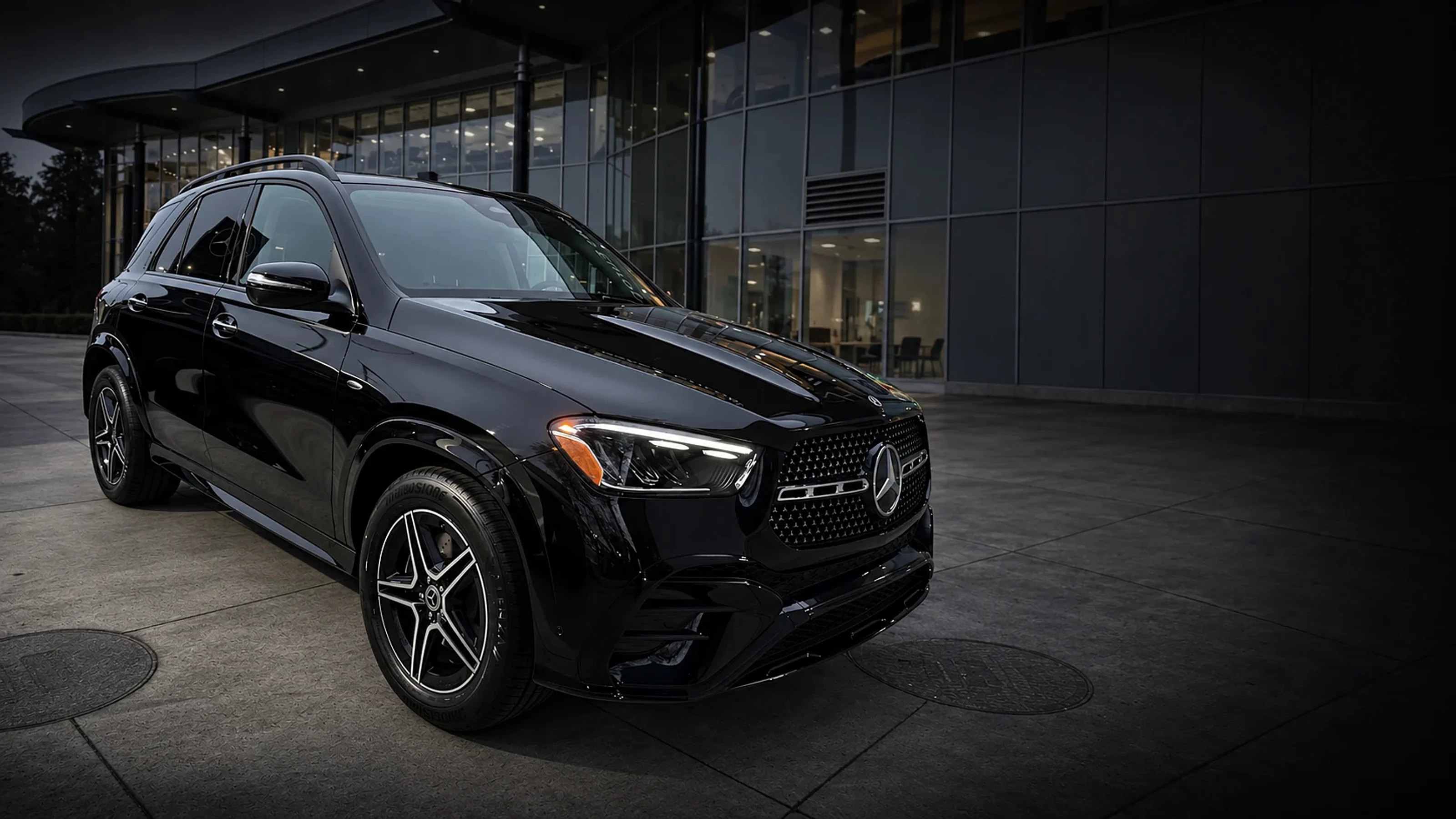 Mercedes-Benz GLE, front three-quarter view outside a showroom at dusk, delivered by AutoBahn Sales & Leasing